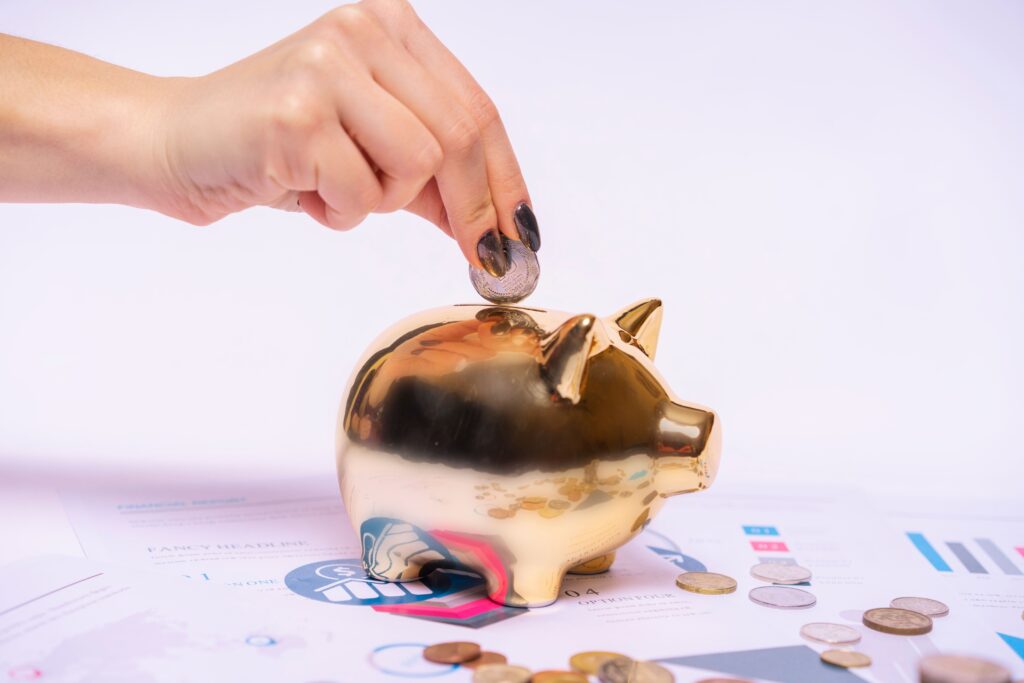 Person saving money in a piggy bank at home