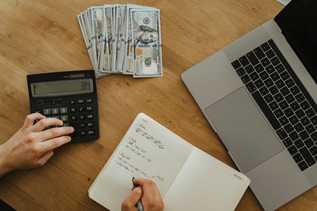 7 Smart Ways to Save Money Every Month Without Sacrificing Your Lifestyle (2) Budget planning with laptop and calculator