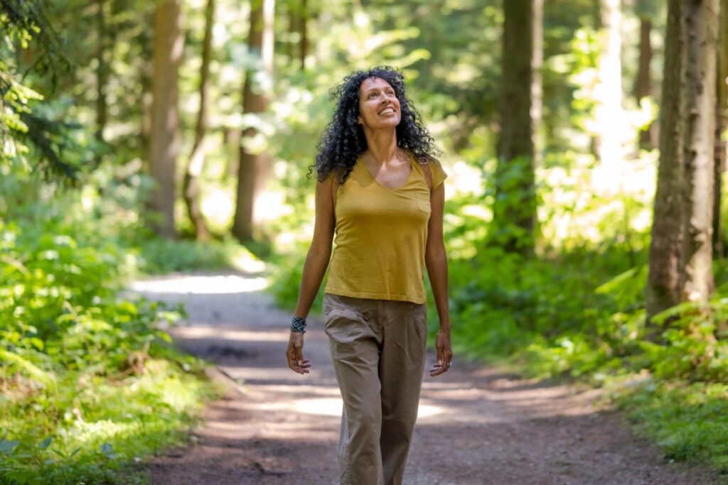 The Benefits of Walking 30 Minutes Every Day (5) Woman enjoying a peaceful walk in nature to improve mental health